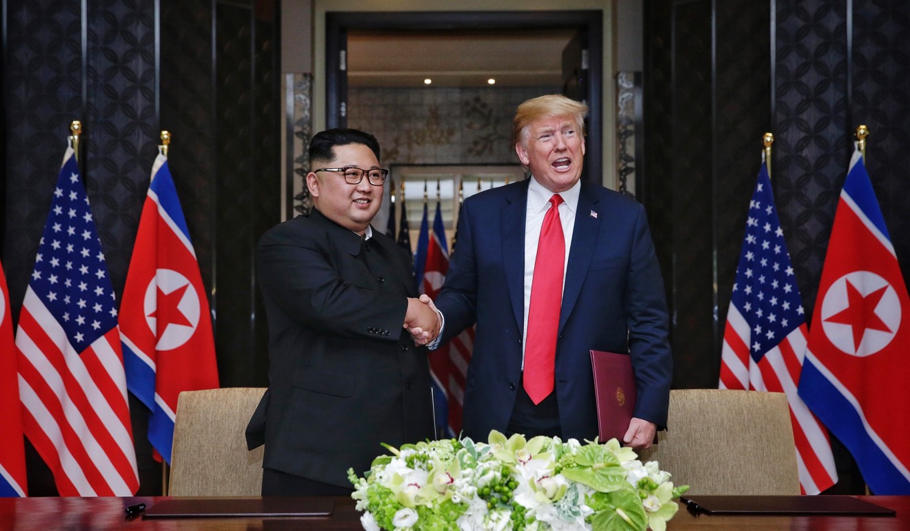 North Korean Chairmain Kim Jong-un and US President Donald Trump shake hands after signing a document during their historic summit in Singapore last June. Photo: EPA