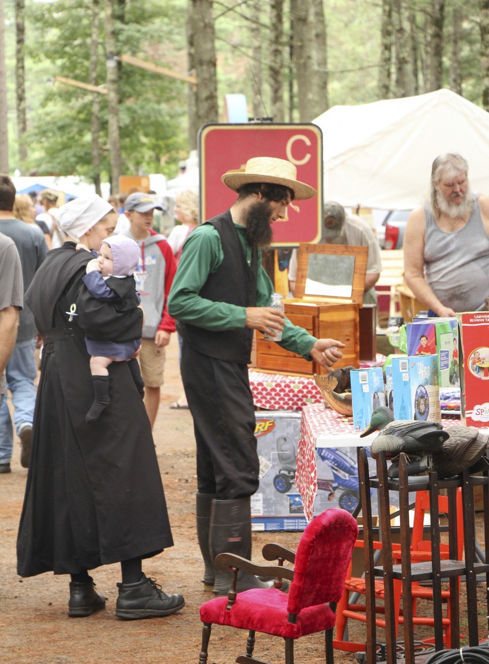 An Amish family shops at a flea market at Lake Arbutus.