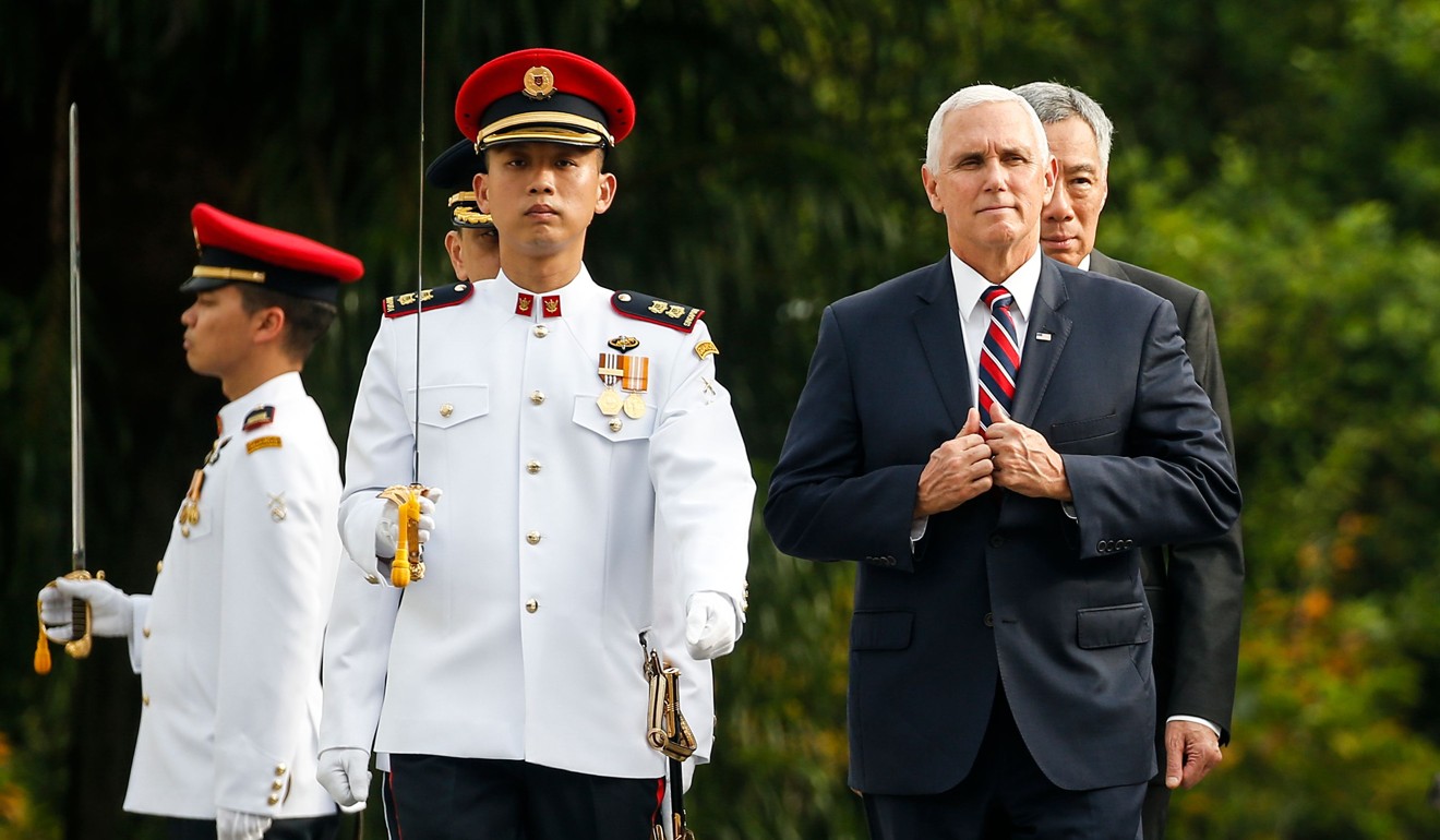 Pence reviews a guard of honour during a welcome ceremony in Singapore. Photo: AFP