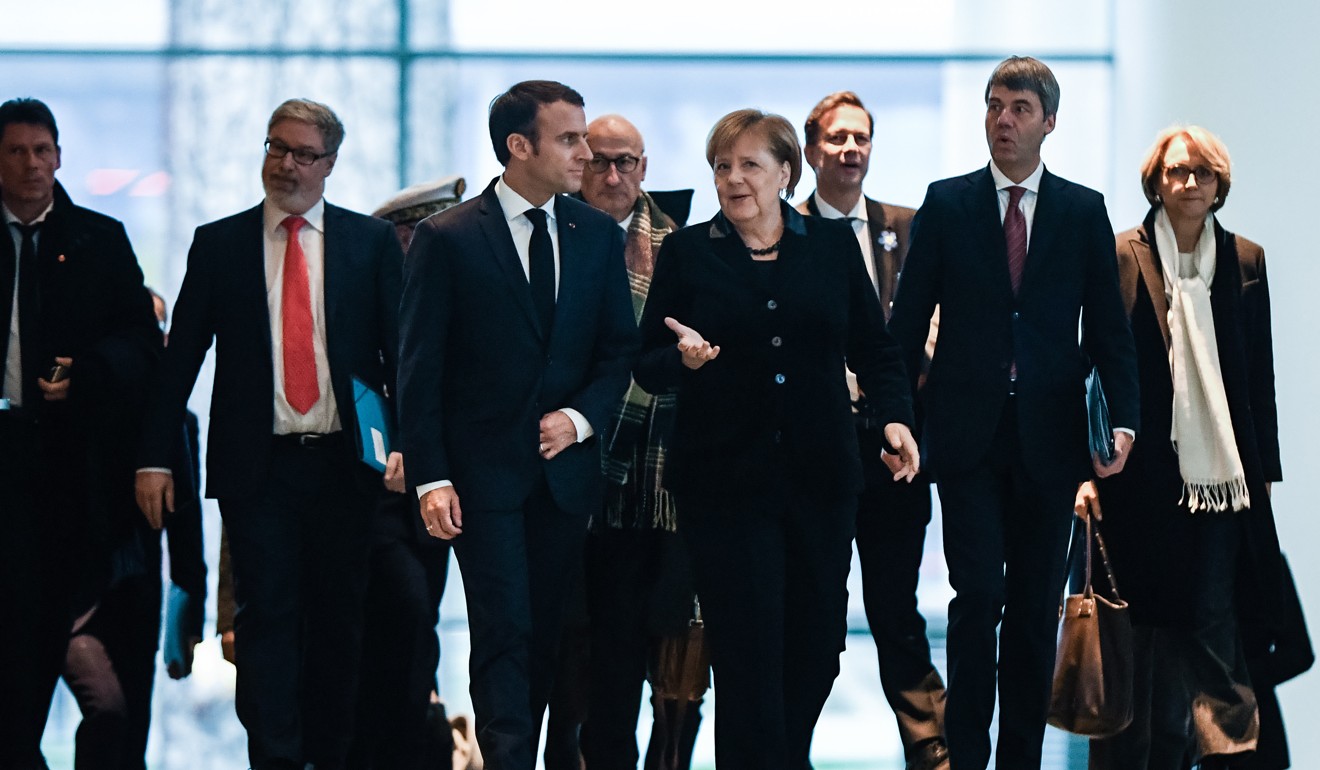 German Chancellor Angela Merkel (right) and French President Emmanuel Macron arrive for a joint press conference at the Chancellery in Berlin. Photo: EPA-EFE