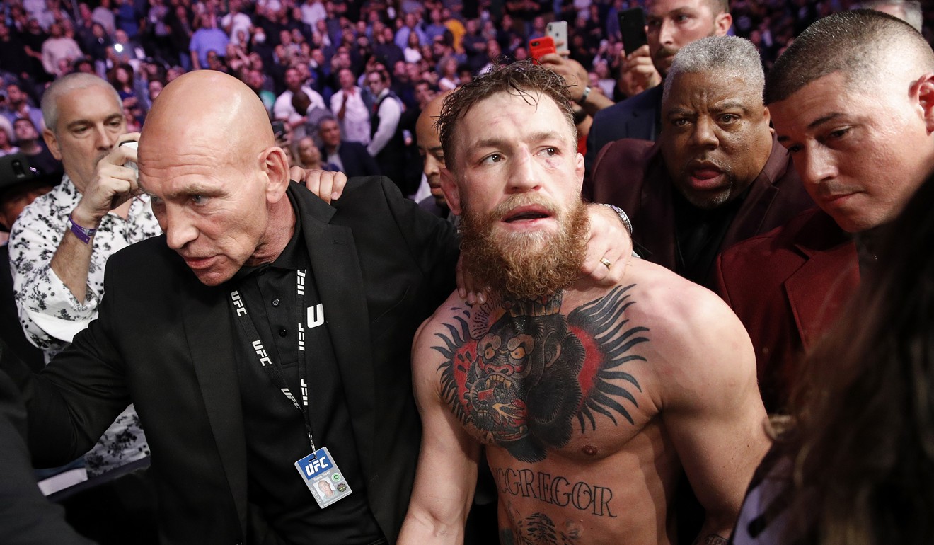 Conor McGregor is escorted from the cage area after fighting Khabib Nurmagomedov at UFC 229. Photo: AP