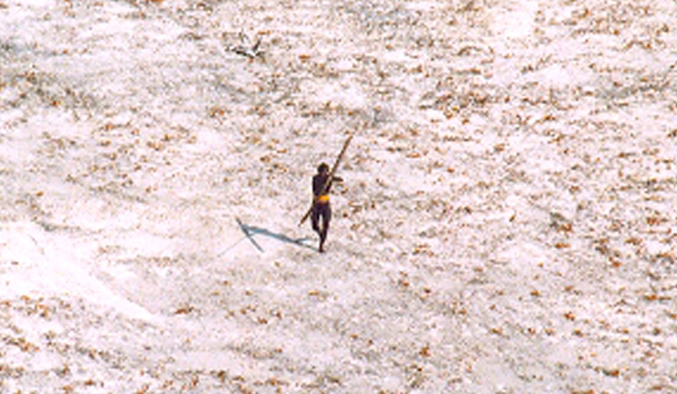 A Sentinelese man takes aim at a helicopter with his bow and arrow. Photo: Reuters