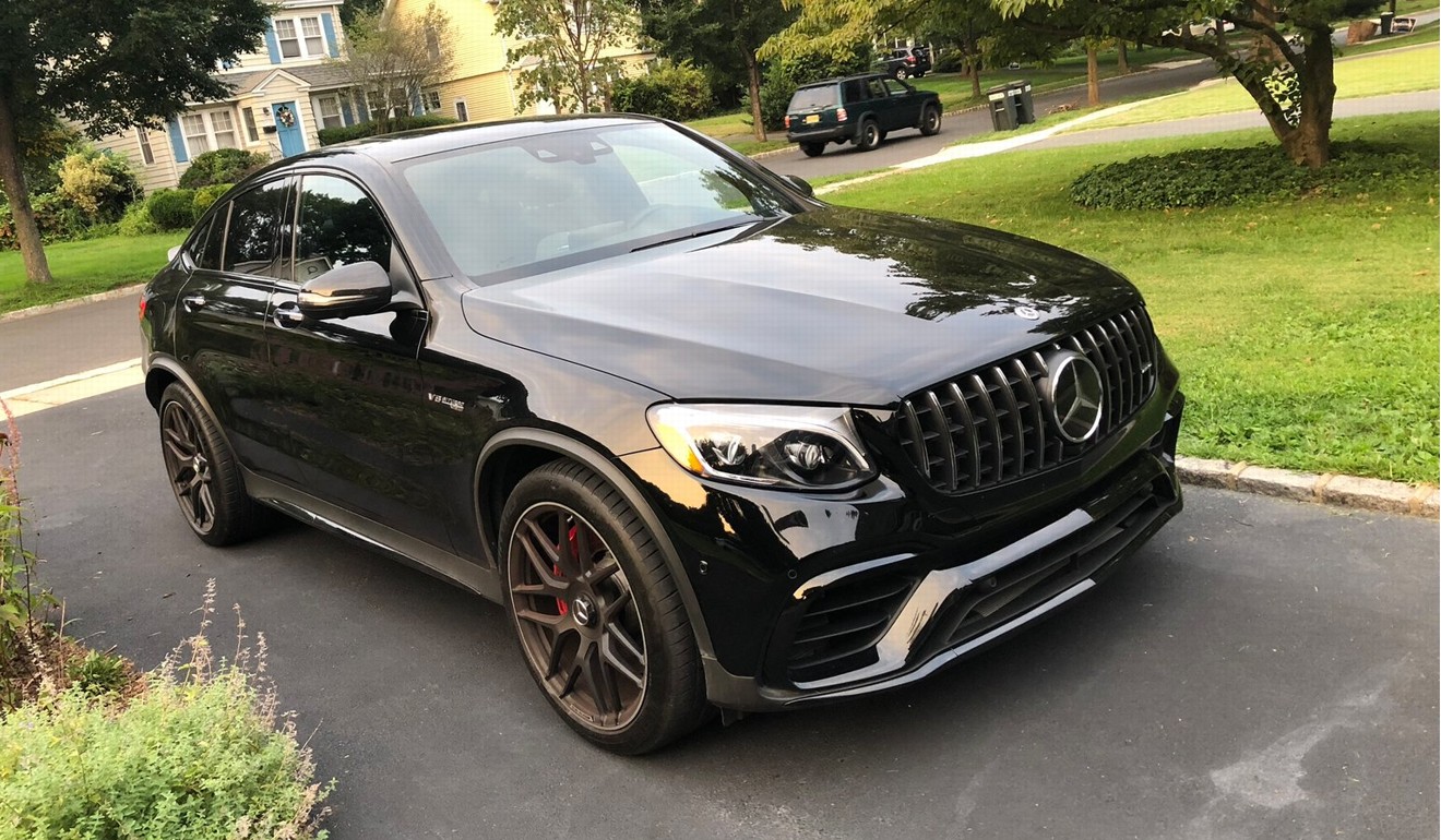 The Mercedes-AMG GLC 63 S Coupe features a large, aggressive-looking front spoiler and matt-black 21-inch wheels.
