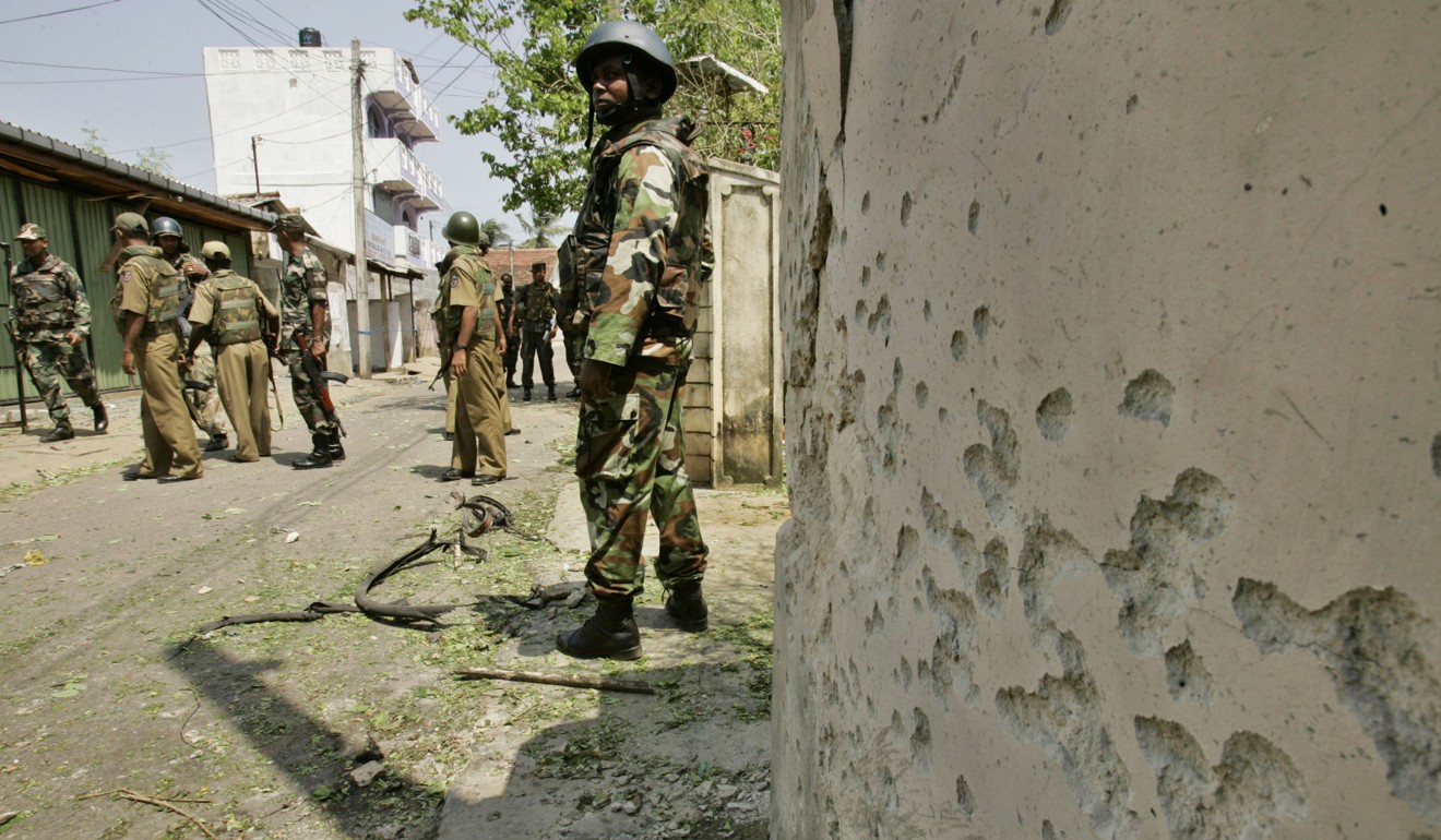 Soldiers investigate an explosion triggered by a bomb in a bicycle in Trincomalee in 2006. Photo: AP