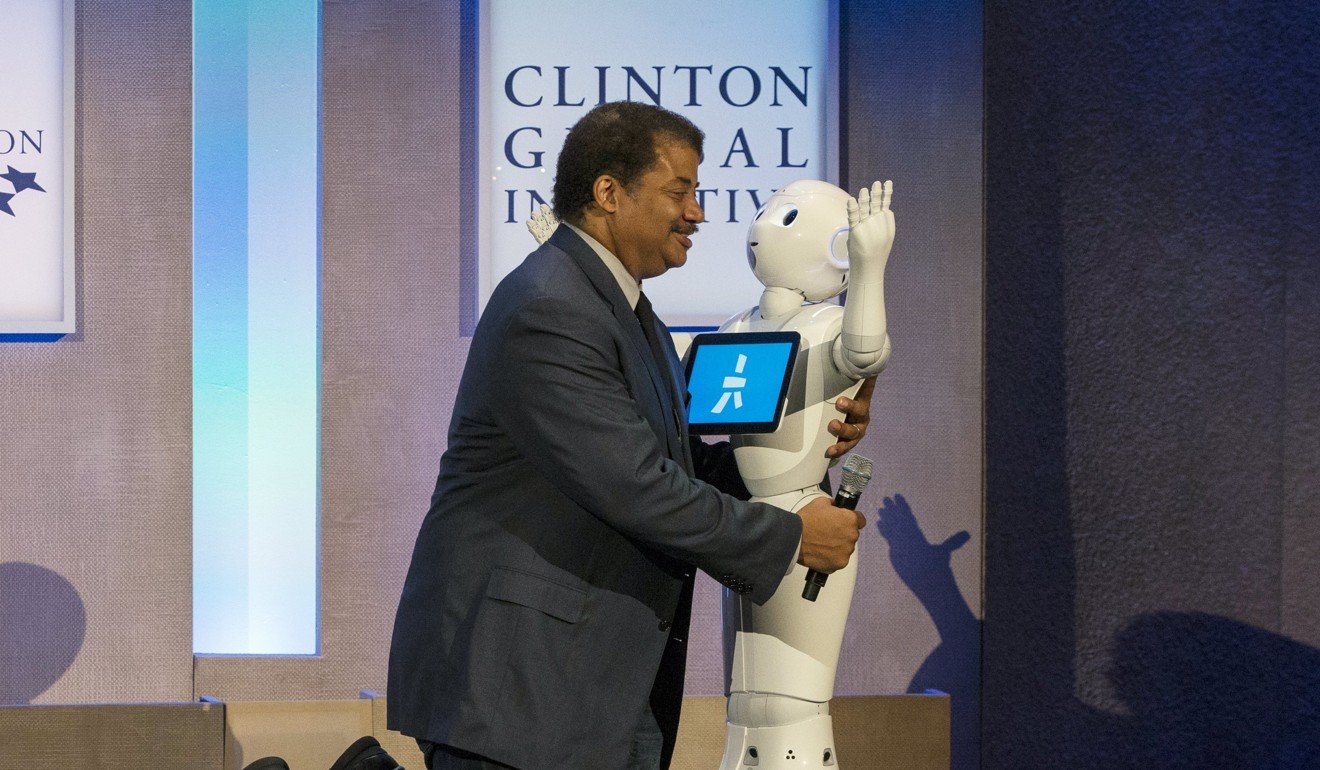 Astrophysicist Neil deGrasse Tyson greets Pepper, a social humanoid robot developed by Aldebaran for SoftBank, on stage during the Clinton Global Initiative's annual meeting in New York in 2015. File photo: Reuters