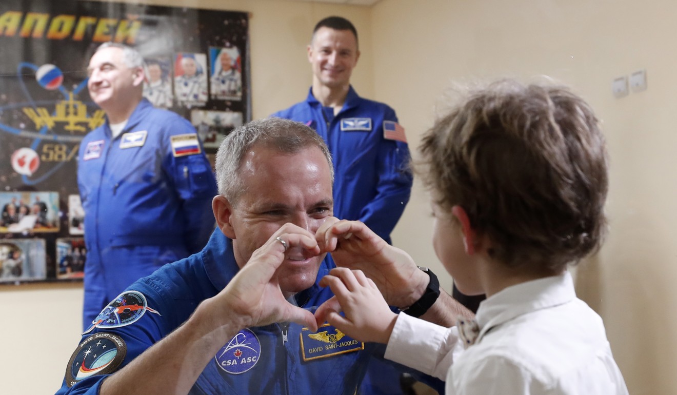 Member of the International Space Station (ISS) expedition 58/59, CSA astronaut David Saint-Jacques chats with his son after a press conference at the Baikonur cosmodrome, in Kazakhstan, 02 December 2018. Photo: EPA-EFE