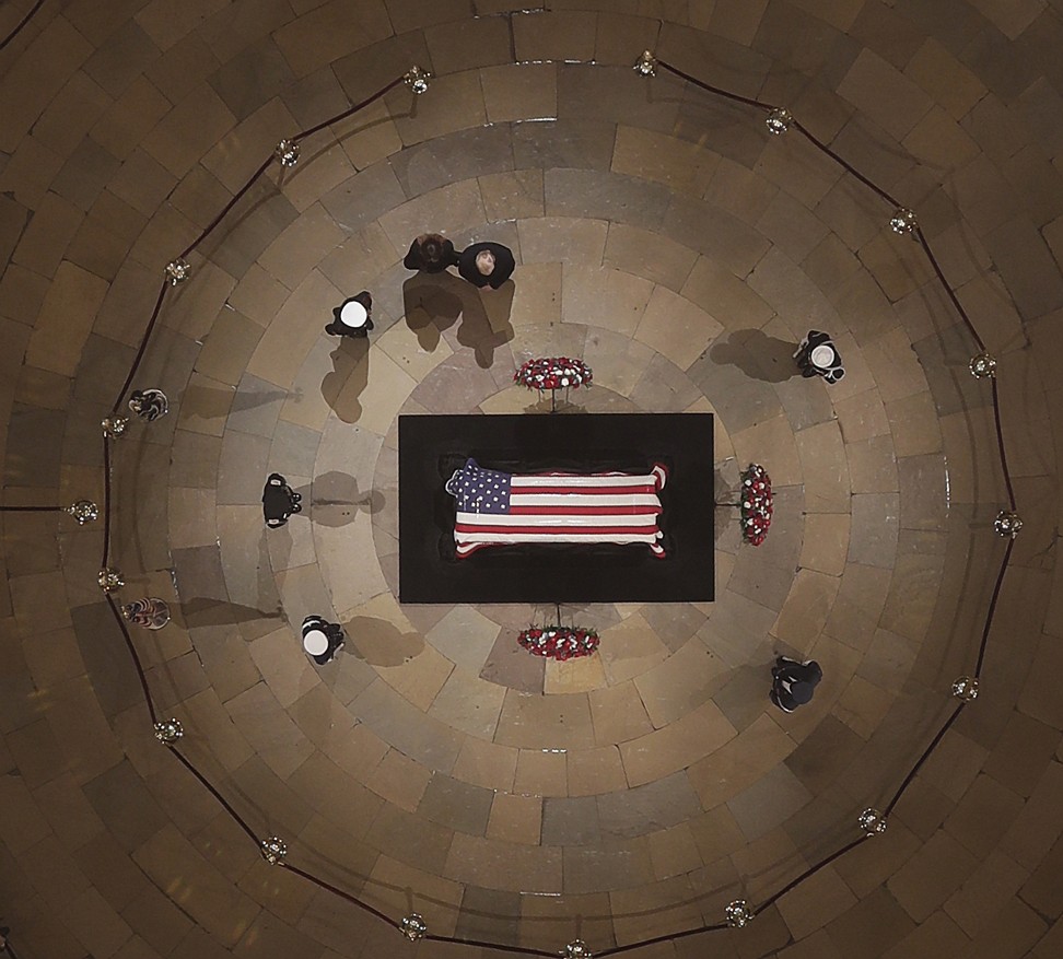 US President Donald Trump and first lady Melania Trump pay their respects as former president George H.W. Bush lies in state in the US Capitol Rotunda in Washington. Photo: EPA