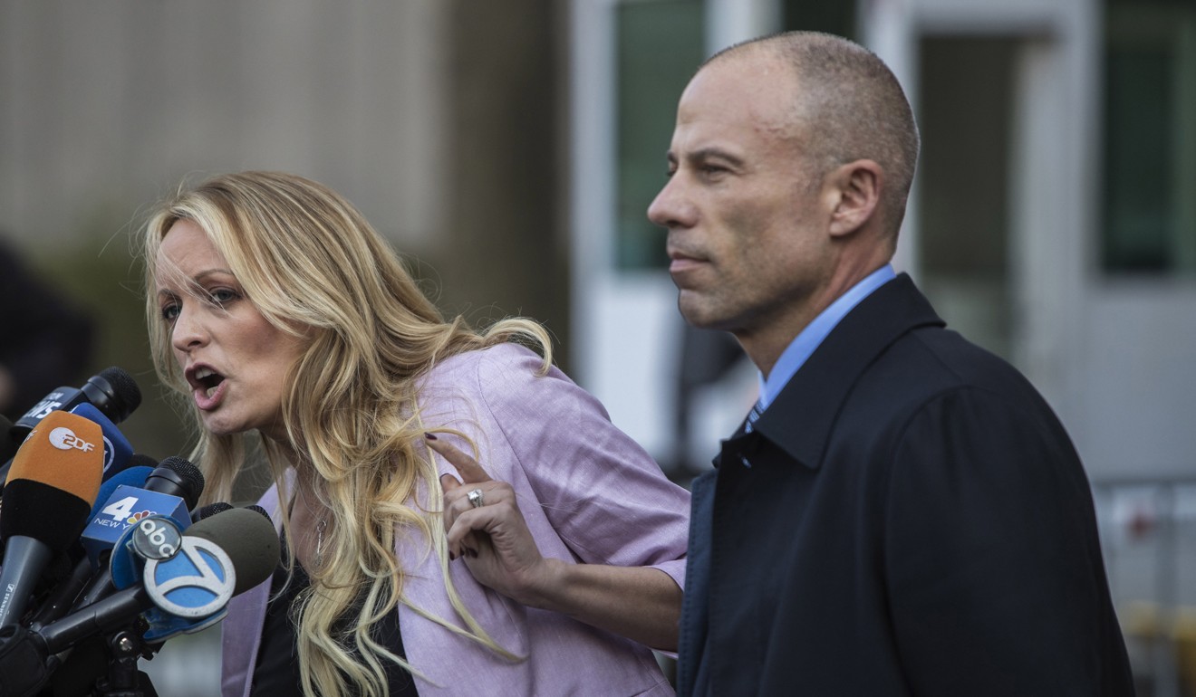 Attorney Michael Avenatti, right, listens outside Federal Court in New York as his client Stormy Daniels addresses the media on April 16. Photo: Bloomberg