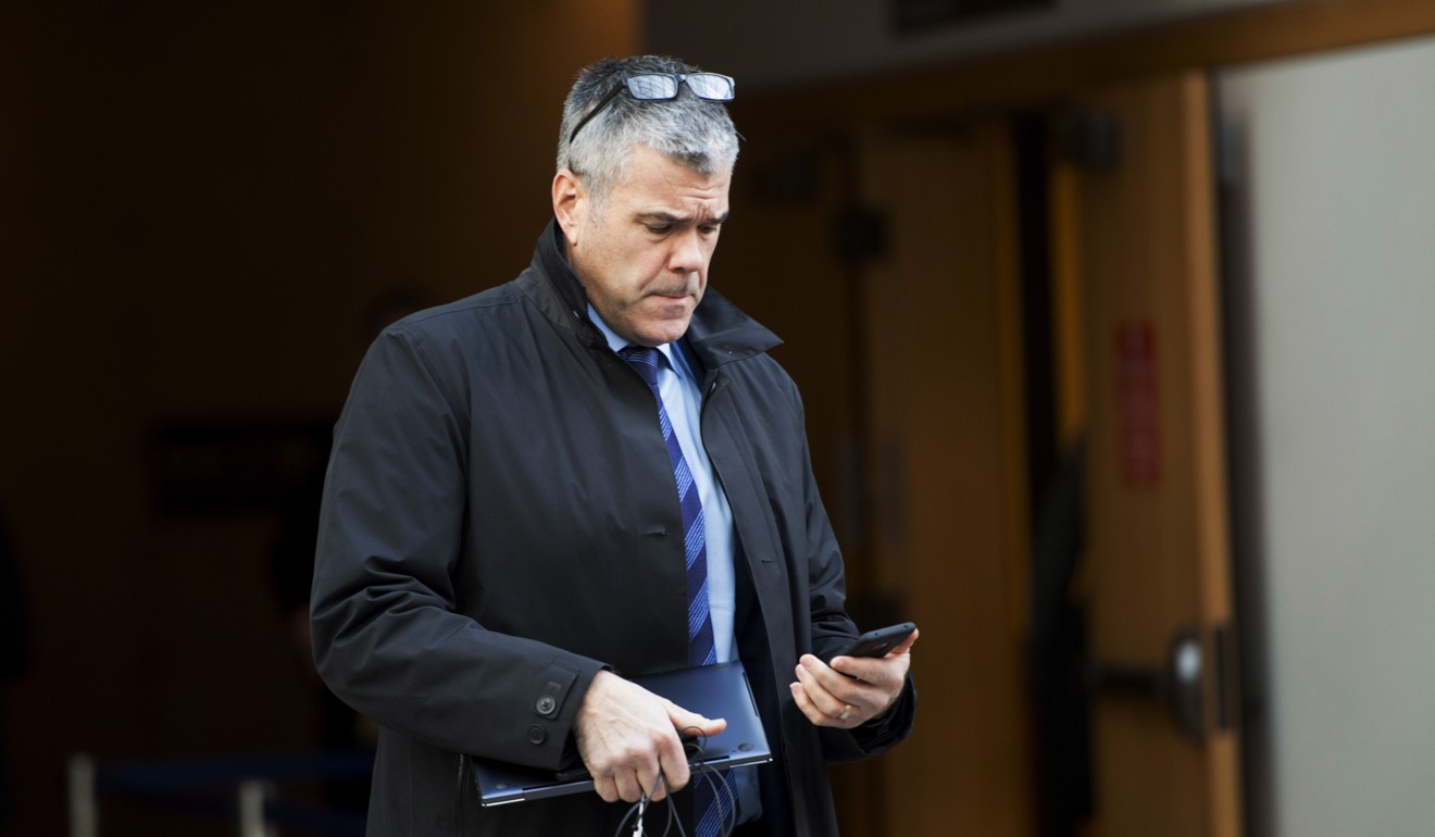 Scott Bradley looks at his mobile phone outside the court in Vancouver. Photo: AP