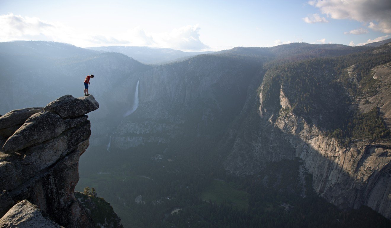Honnold peers over the edge of Glacier Point in Yosemite National Park. Photo: National Geographic/Jimmy Chin