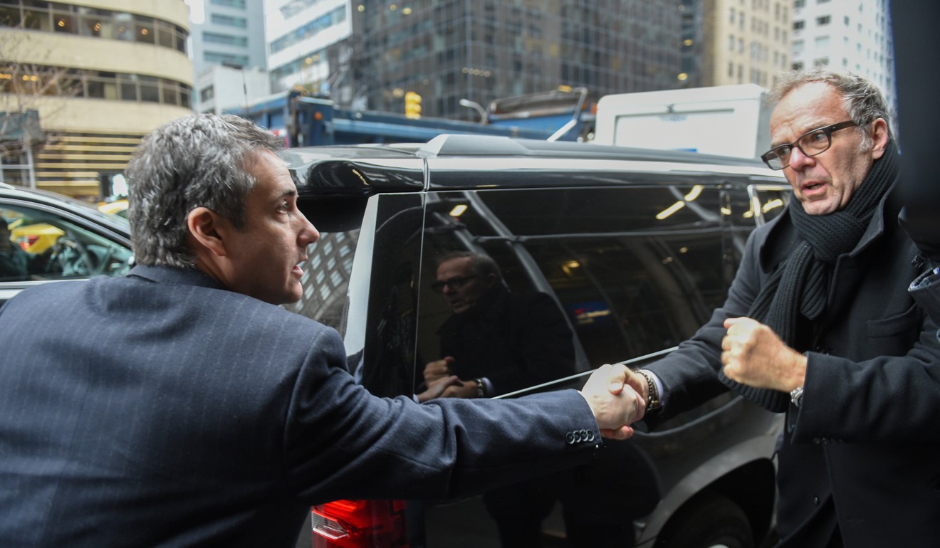 Michael Cohen (left) is greeted by a supporter as arrives home after his sentencing in New York. Photo: Reuters