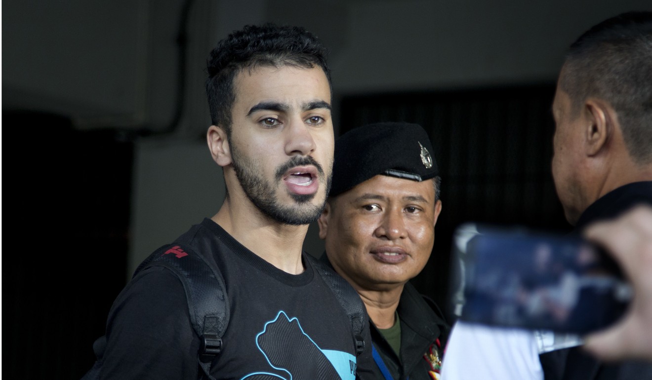 Araibi speaks to the media while being escorted into court in Bangkok. Photo: AP