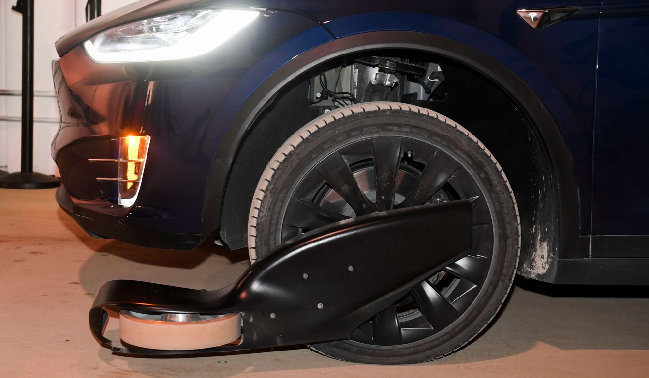 A modified Tesla Model X electric vehicle enters the tunnel with guide wheels attached. Photo: AFP