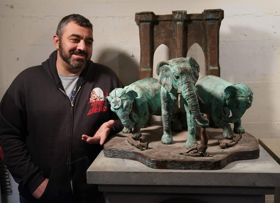 Artist Joseph Reginella poses at his studio in Staten Island, New York, next to his Brooklyn Bridge Elephant Stampede memorial, a recreation in bronze of that fateful day in 1929 when P.T. Barnum’s pack of circus elephants allegedly went rogue, squashing spectators all along the bridge – ‘one of the most horrific land mammal tragedies in our nation’s history’, the plaque says. Photo: AFP