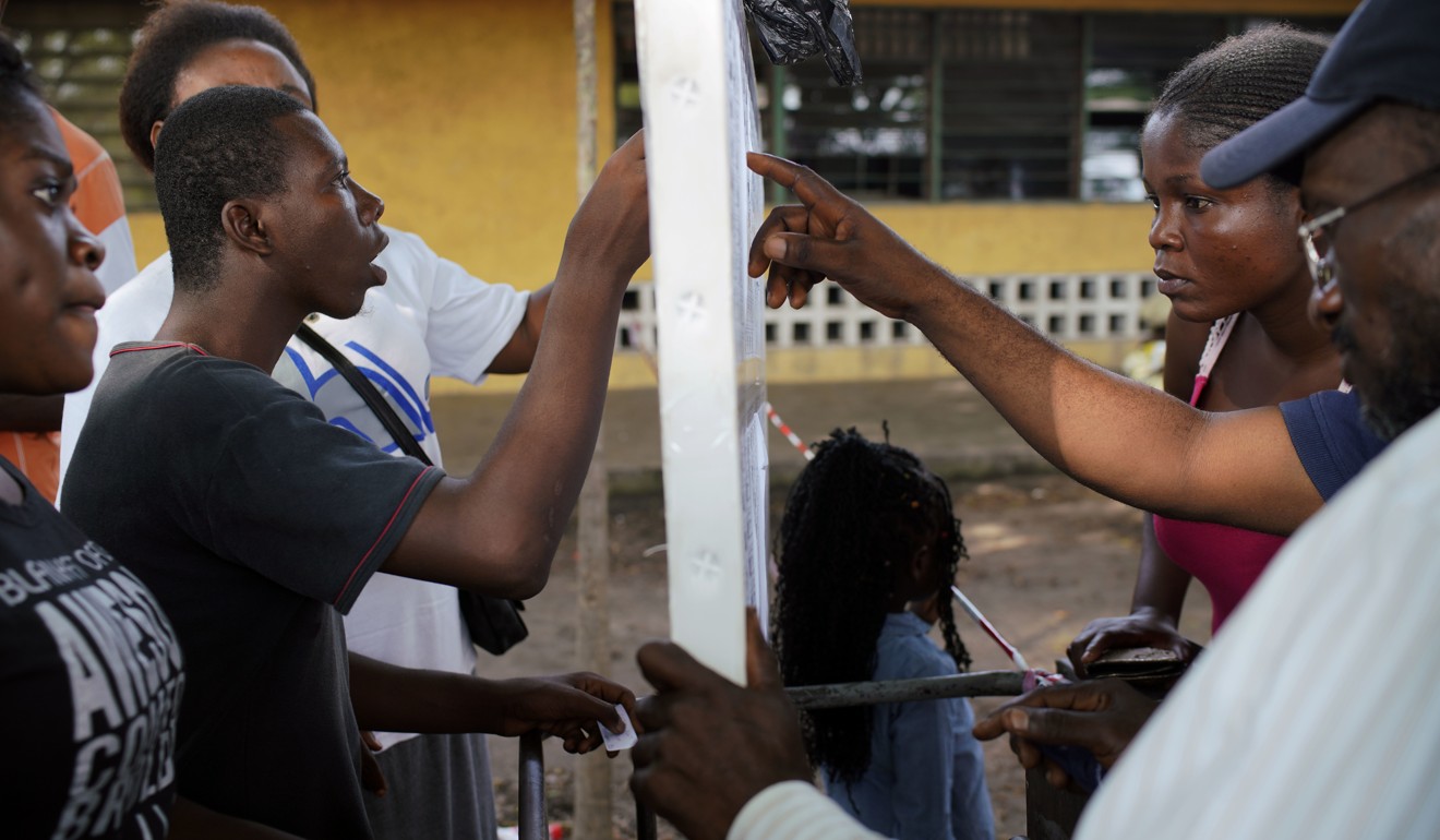 Congolese voters check registration lists before voting in Kinshasa. Photo: AP