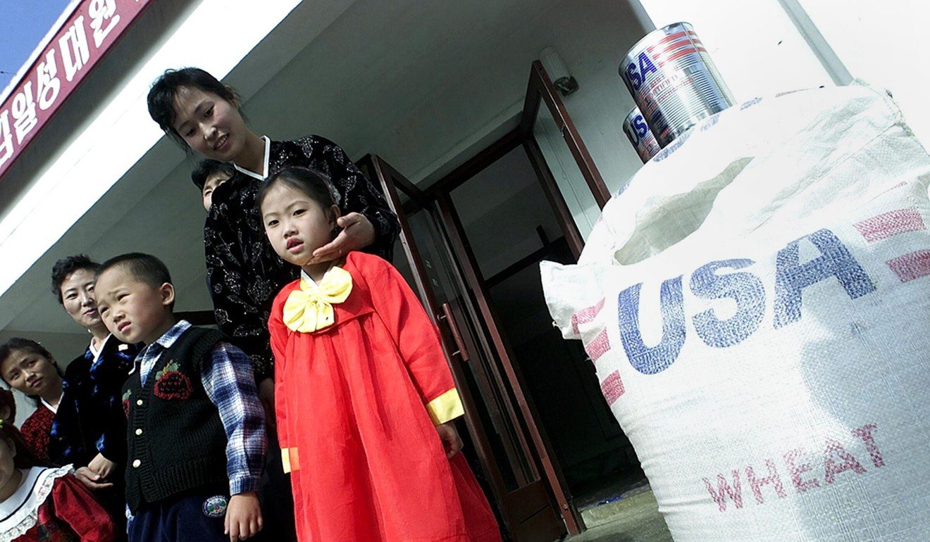 North Korean children stand beside packages of US wheat before the US imposed sanctions on the country for its nuclear weapons programme. Photo: AFP