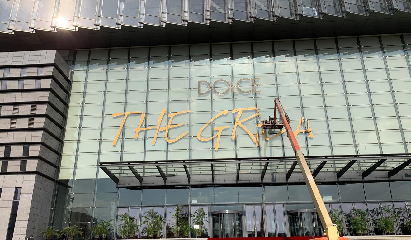 Workers remove a sign in Shanghai that reads “Dolce & Gabbana The Great Show” after the fashion brand cancelled a show amid a racism row. China, or its consumers, currently exert influence through money. Photo: Reuters