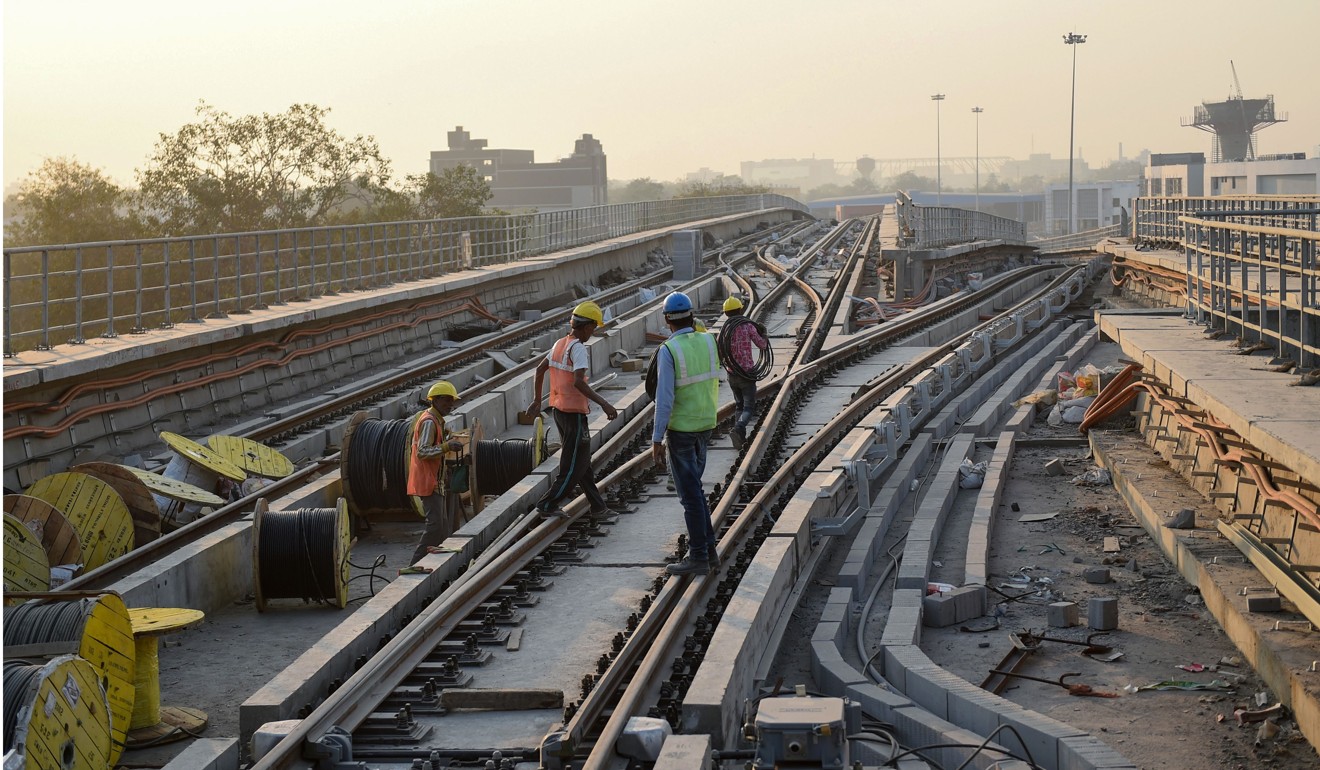 Indian labourers working at the Apparel Park Metro Rail Station in Ahmedabad on January 1, 2019. Photo: AFP