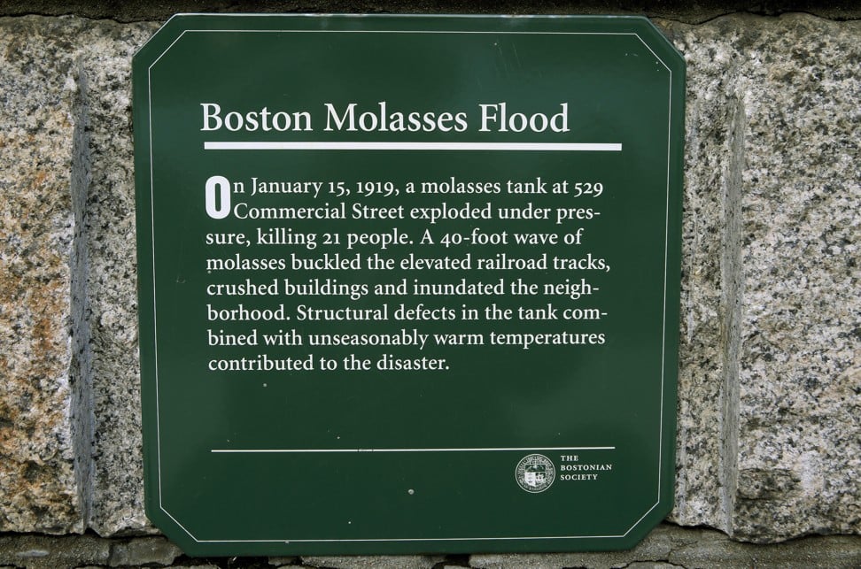 In this Wednesday, Jan. 2, 2019, photo, a placard commemorating the Great Molasses Flood rests on a wall at the site of the 1919 disaster in Boston's North End neighborhood. The city will mark the centennial of the disaster, when the tank containing more than 2 million gallons of molasses erupted, killing 21 people and injuring 150 others. (AP Photo/Steven Senne)