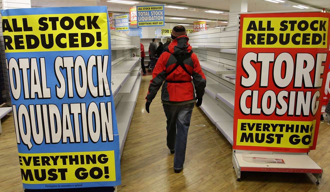 A woman walks past empty shelves at a supermarket in Nuneaton, central England in December 2008. Photo: Reuters