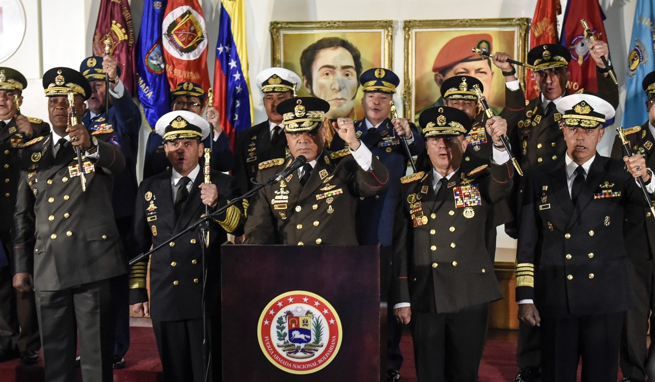 Venezuelan Minister of Defence Vladimir Padrino, centre, gestures while speaking during a press conference with the nation’s the military high command in Caracas on Thursday. Photo: Bloomberg