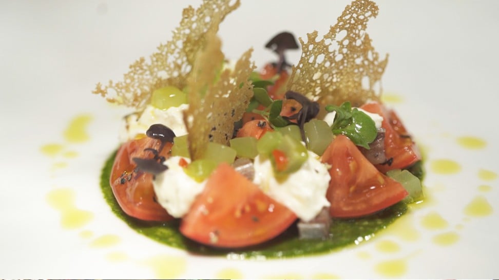 Arcane restaurateur and chef Shane Osborn’s Japanese fruit tomato with burrata cheese, basil pesto, celtuce and green olives.