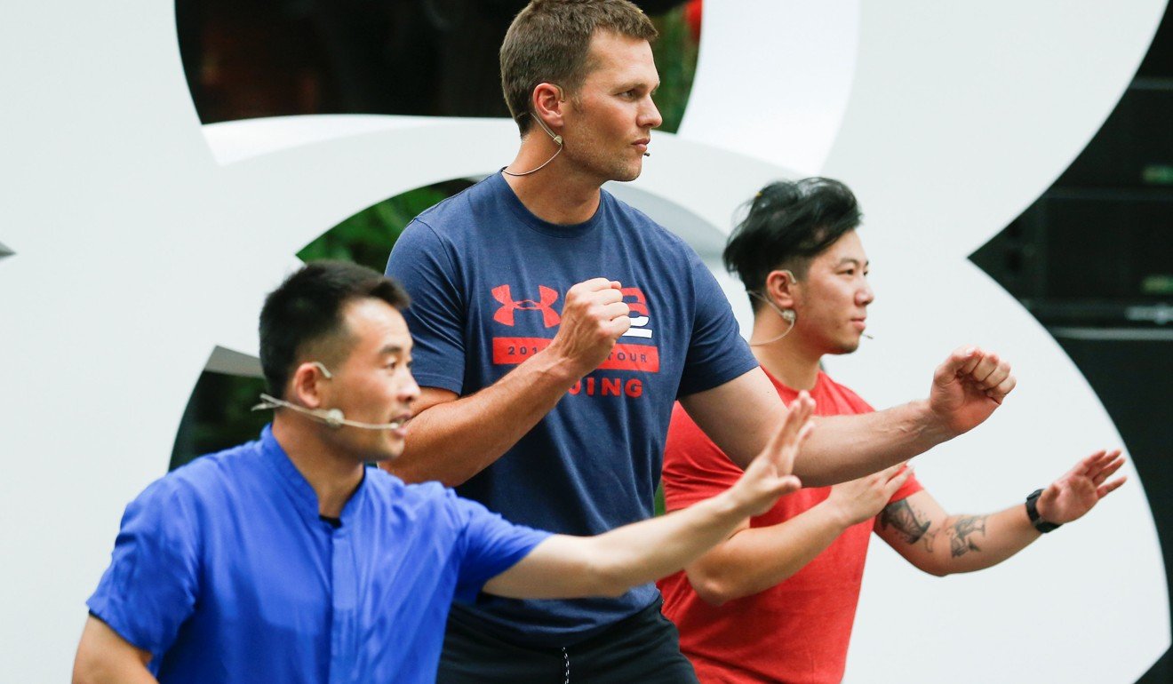 Chinese martial arts master Sunflower shows fight moves to Tom Brady (centre) during a promotional training event in Beijing, China. Photo: Reuters