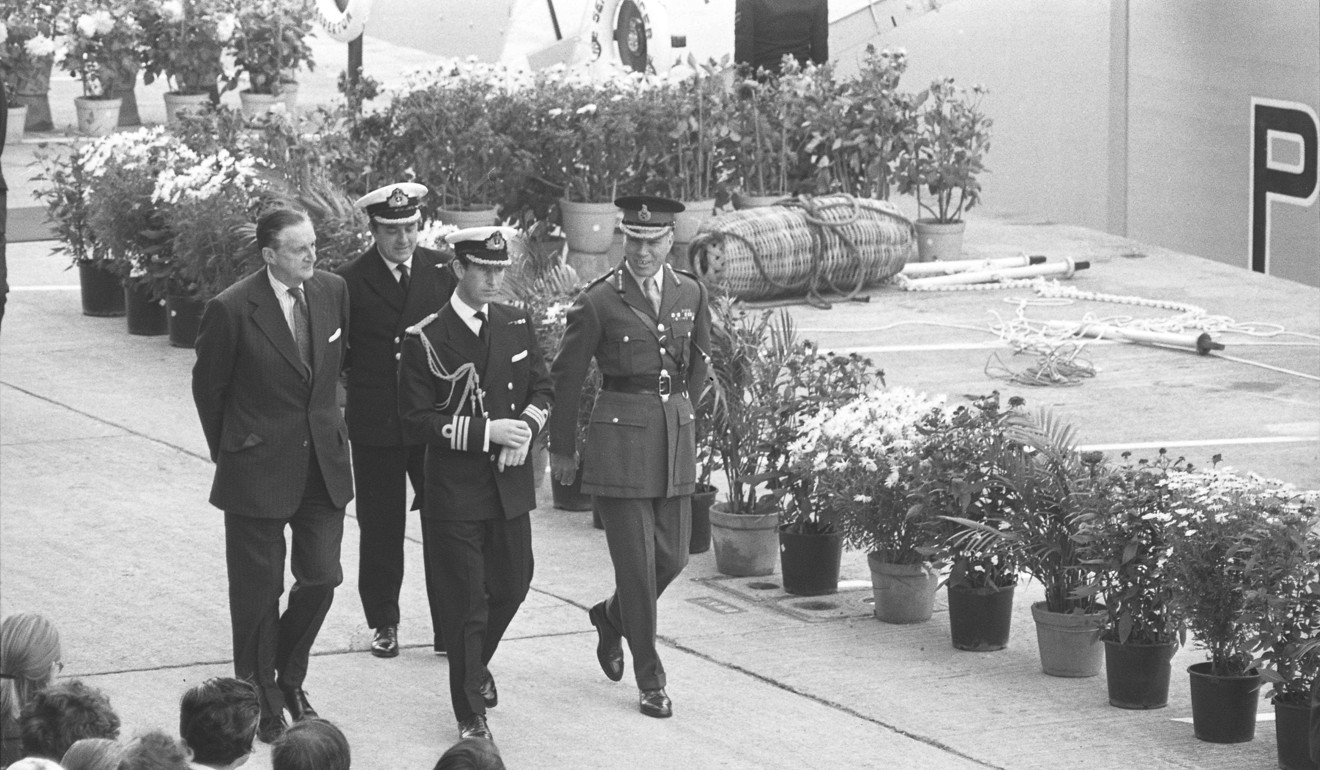 Prince Charles (front centre) is accompanied by Governor Murray MacLehose (front left) and Commander British Forces Major-General Roy Redgrave on his arrival at HMS Tamar. Photo: Handout