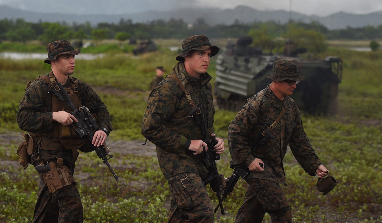US marines walk past their amphibious assault vehicle during the Philippines-US amphibious landing exercise at a naval training base facing the South China Sea in San Antonio town, Zambales province, on October 7, 2016. Photo: AFP