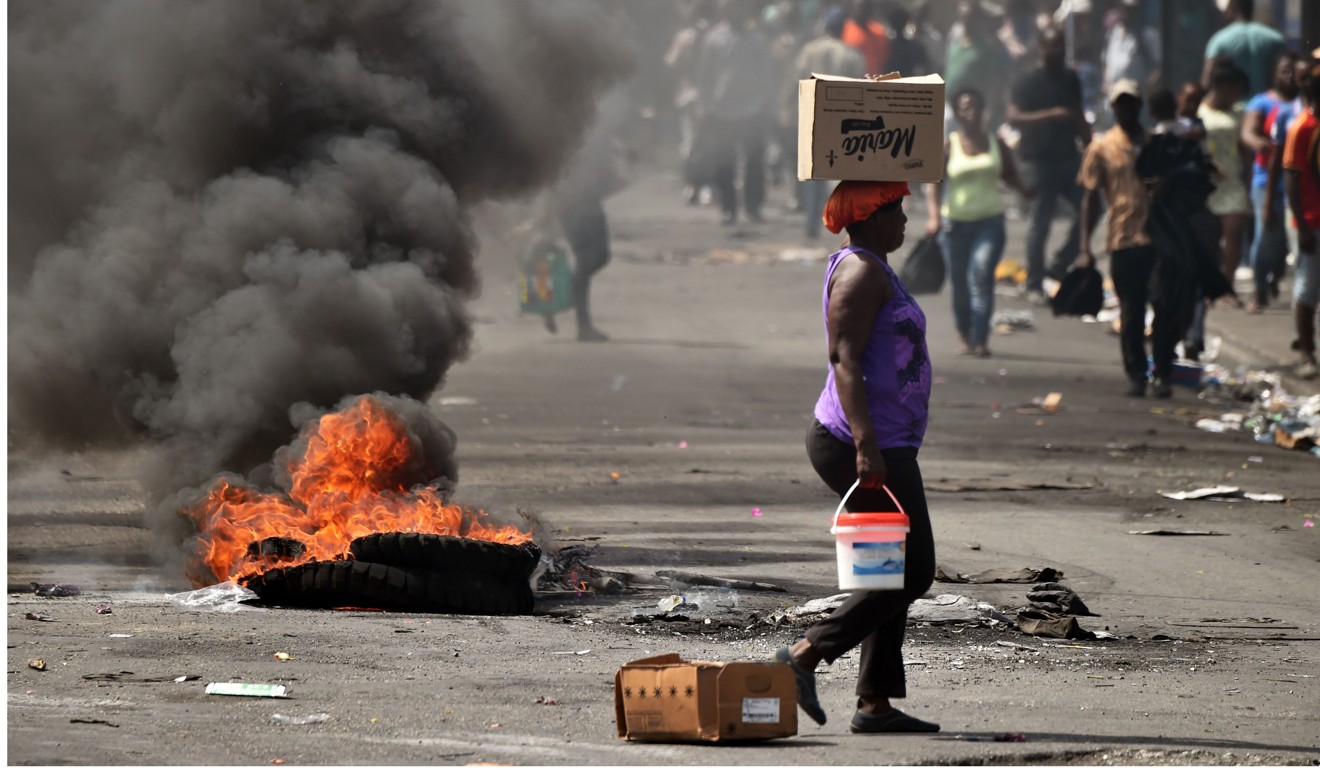 A tire burns on a street in Petion Ville in the Haitian capital Port-au-Prince on February 17, 2019. Photo: AFP