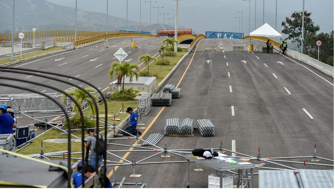 Workers assemble a platform for the concert organised by Richard Branson on the Tienditas International Bridge, in Cucuta, Colombia. Photo: AFP
