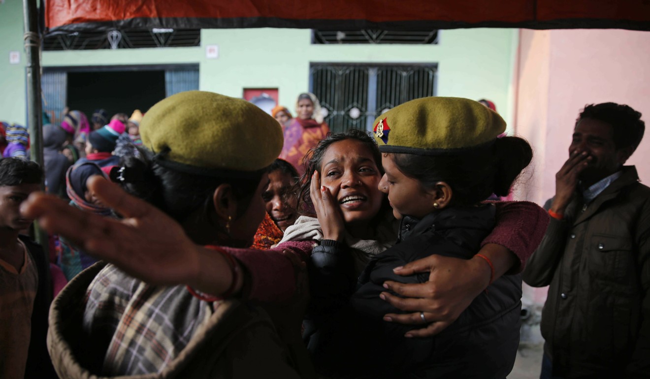 A policewoman comforts a relative of a paramilitary soldier, who was killed in the Kashmir attack. Photo: AP
