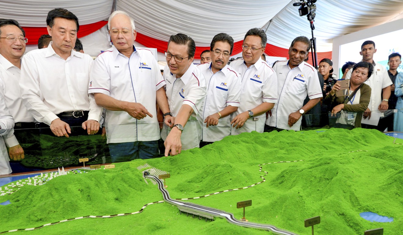 Former Malaysian leader Najib Razak, third from left, looks at a model of the proposed East Coast Rail Link. Photo: AP