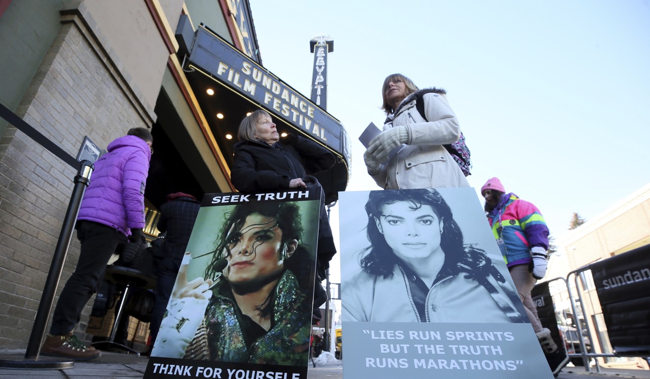 In this January 25 file photo, Michael Jackson fans Brenda Jenkyns, left, and Catherine Van Tighem protest outside the premiere of the “Leaving Neverland” documentary in Park City, Utah. The pair drove from Calgary, Canada, to protest. Photo: AP
