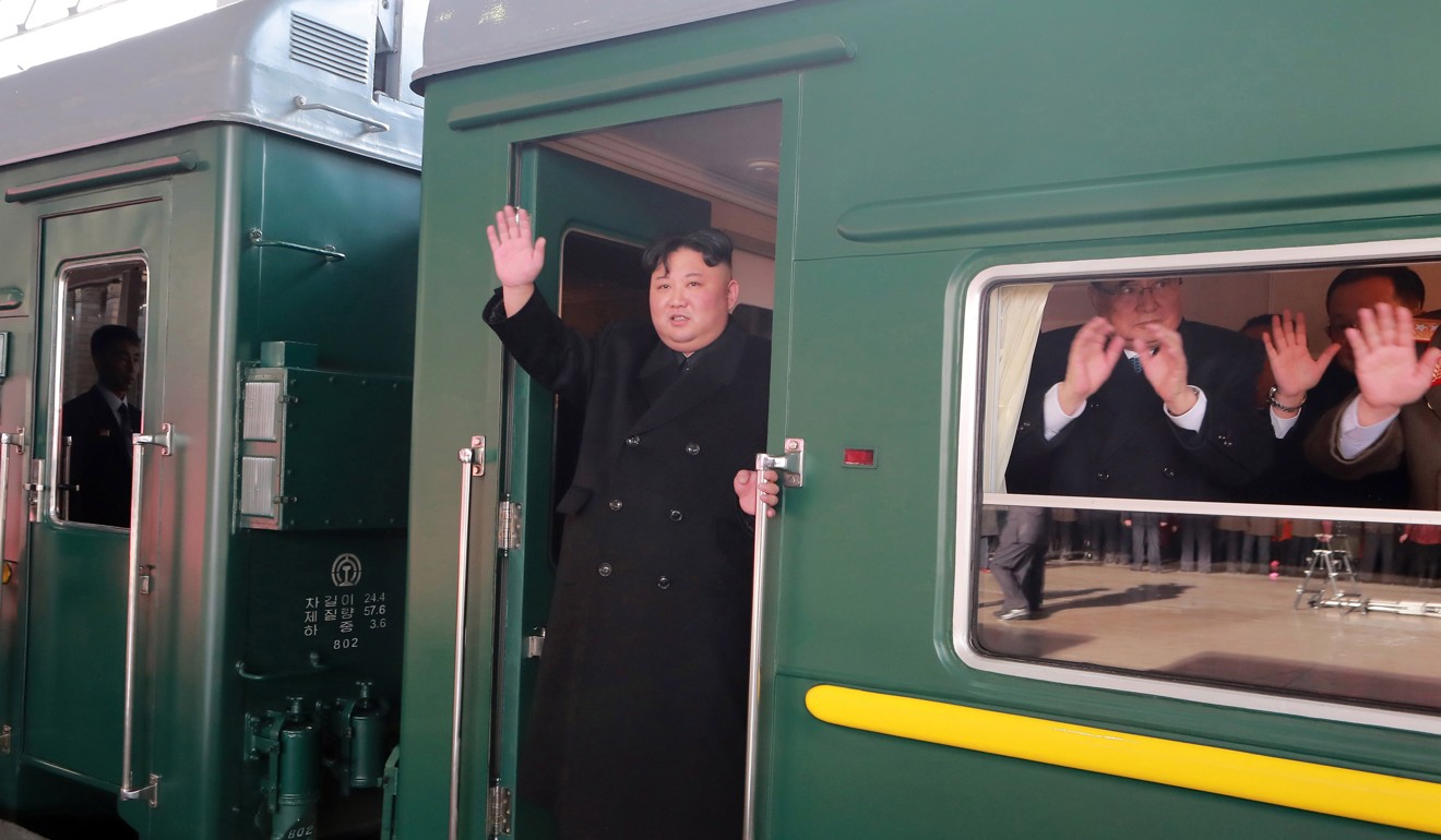 North Korean leader Kim Jong-un waves as he boards a train in Pyongyang. Photo: EPA
