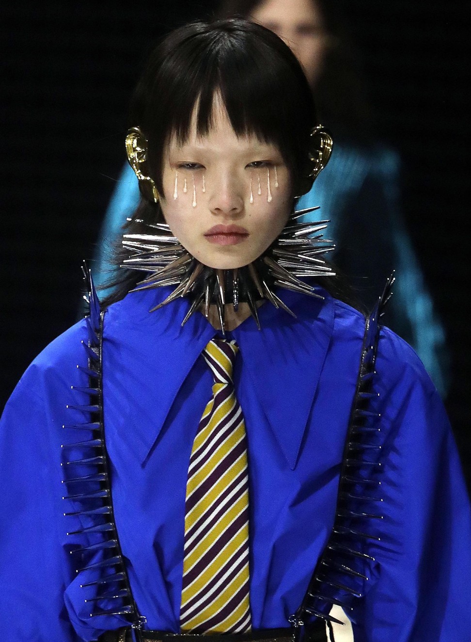 A model presents a creation by Gucci with Pierrot-style tears streaming down her cheeks. Photo: EPA-EFE