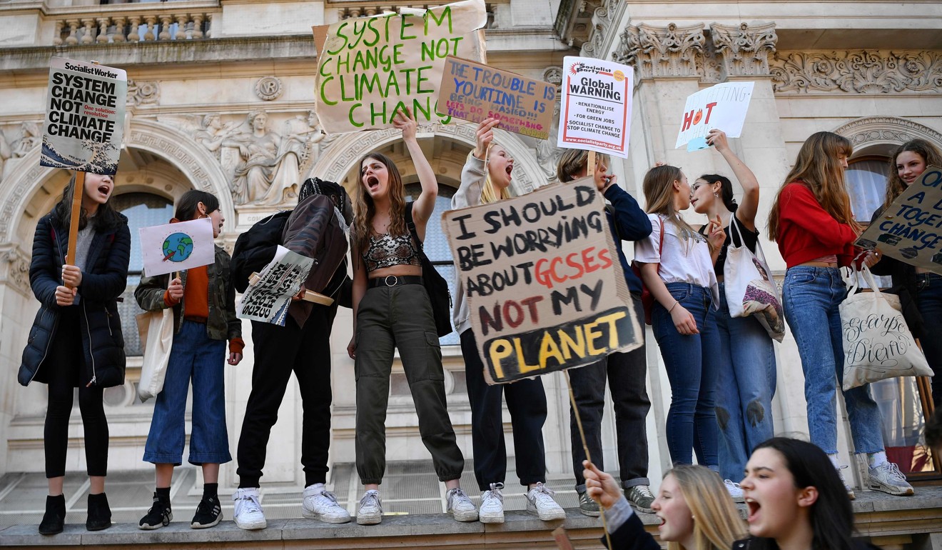 Young demonstrators hold placards during a climate change protest in London. Photo: AFP