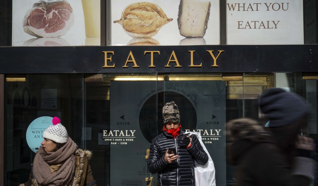 Customers exit Eataly, a New York City food emporium that Batali sold his stake in. Photo: AFP