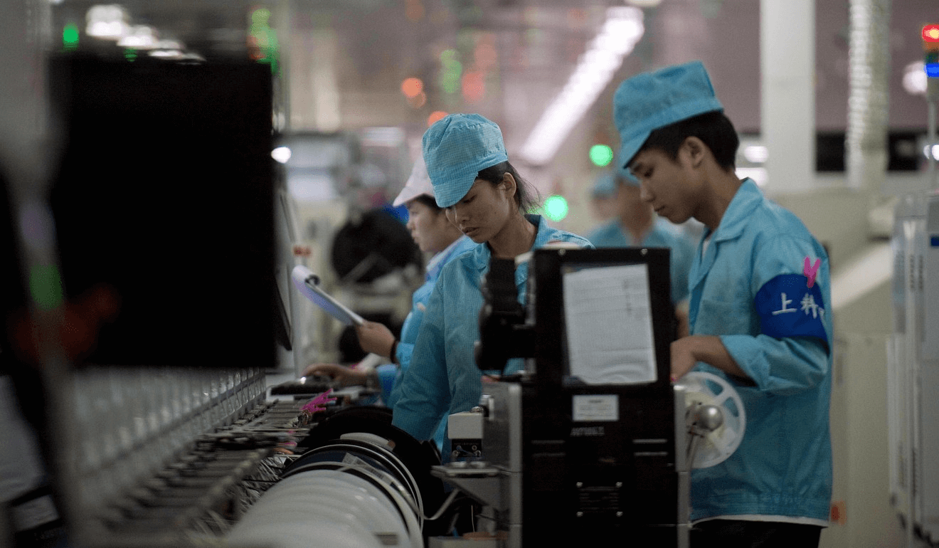 Workers at Oppo’s main factory in Dongguan. (Picture: AFP)  