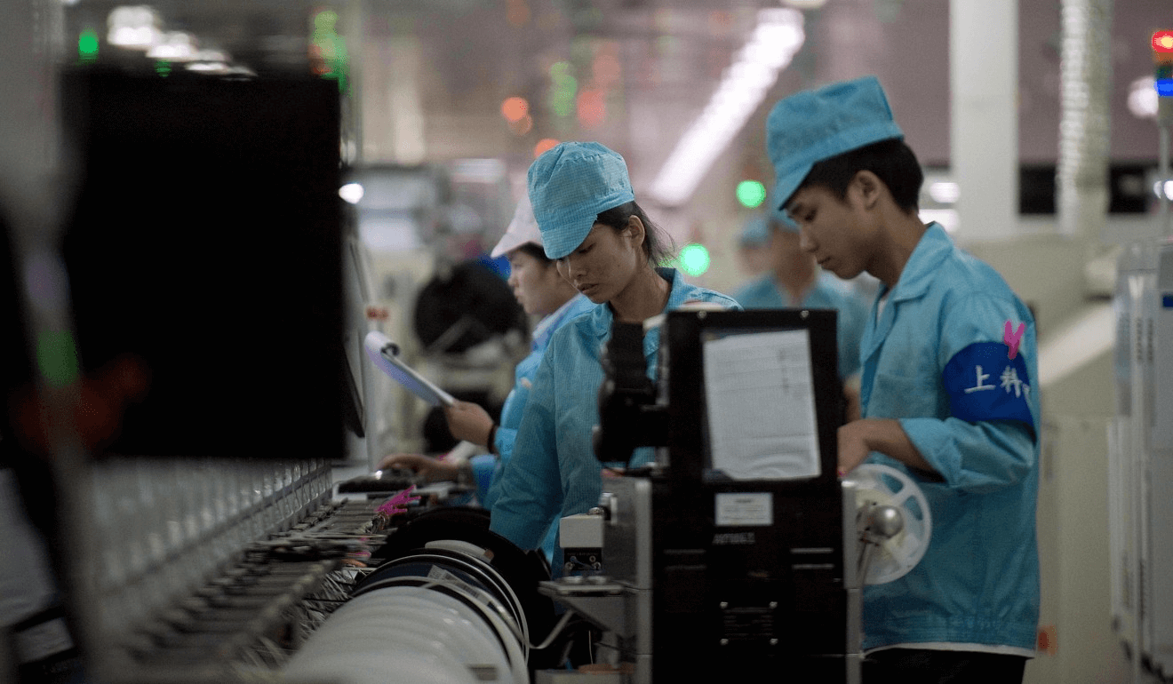 Workers at Oppo’s main factory in Dongguan. (Picture: AFP)