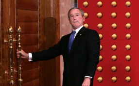 George W. Bush jokingly makes a face as he tries to open a locked door as he leaves a press conference in Beijing in 2005. File photo: AP
