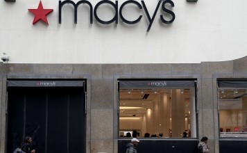 People walk in front of a Macy's Store in Brooklyn, New York. May's stock dropped more than 17 per cent following a disappointing earnings report and other stores suffered from the weakening performance of the sector. Photo: EPA