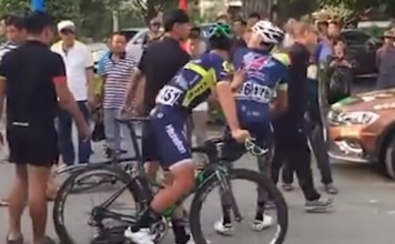 A confrontation breaks out as Wang Xin picks up his bike following the fall. Photo: Youtube