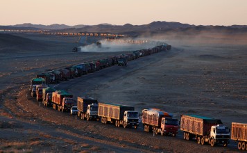 Thousands of heavy-duty trucks loaded with coal make their way along the sole road through the Gobi desert in Mongolia to the Chinese border. Photo: Reuters