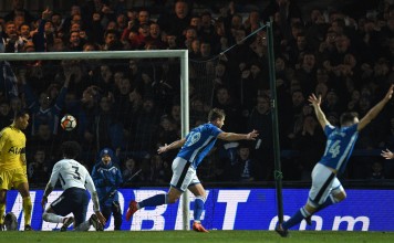 Rochdale’s Steven Davies (C) celebrates arms aloft with teammates after scoring his side’s late equalising goal during the FA Cup fifth round match against Tottenham Hotspur at the Crown Oil Arena in Rochdale. Photo: AFP