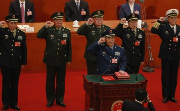 Newly appointed vice-chairman of the Central Military Commission Xu Qiliang (at podium) leads the military oath-taking ceremony at the National People’s Congress in Beijing on Sunday. Also pictured are CMC vice-chairman Zhang Youxia (back row, centre) and regular members (from left) Zhang Shengmin, Li Zuocheng, Wei Fenghe and Miao Hua. Photo: EPA-EFE