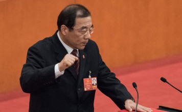 Yang Xiaodu takes an oath after being elected director of the new National Supervisory Commission at the Great Hall of the People in Beijing on Sunday. Photo: AFP