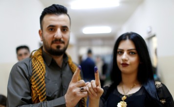 A Kurdish man and woman show their ink-stained fingers, during parliamentary elections in the semi-autonomous region in Arbil, Iraq. Photo: Reuters