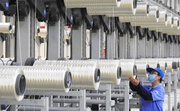 An employee works on a carbon fibre production line at a factory in Lianyungang, in China’s eastern Jiangsu province, on August 9. China’s PMI fell in August, setting alarm bells ringing in the manufacturing sector. Photo: AFP