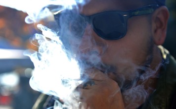 Smoking marijuana in Vancouver on October 17. Statistics Canada says 5.4 million Canadians will buy cannabis from legal dispensaries in 2018. Photo: AFP